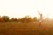Mid Caucasian woman practicing slackline at sunset in the forest.