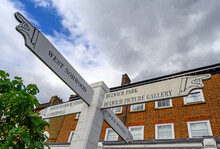 A Local Sign With Pointing Hands In Dulwich Village, Greater London, UK. The Sign Shows Directions To Local Dulwich Landmarks And Nearby Places. Dulwich Is In South London.