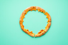 Pizza Crust Only Isolated On A Green Background. Pizza Leftovers Top View.