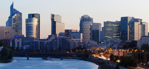 Skyscrapers of La Defense financial district and Seine river at night , Paris.