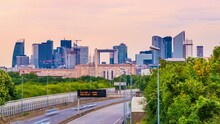 4k Timelapse Of Skyscrapers Of Paris Business District La Defense On A Cloudy Summer Day And The Traffic On Highway A14. From Houilles, West Of Paris, France.Camera Fixed Position