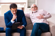 © Elnur - Young male lawyer visiting old man in testament concept