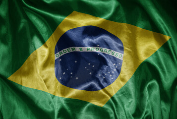 Wall Mural - colorful shining big national flag of brazil on a silky texture.