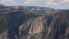 Wide Open View Of Waterfall, Mountains, And Valley In Yosemite National Park.