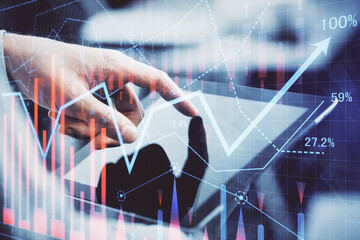 Multi exposure of man's hands holding and using a phone and financial chart drawing. Market analysis concept.