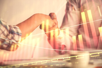 Double exposure of forex graph hologram and handshake of two men. Stock market concept.