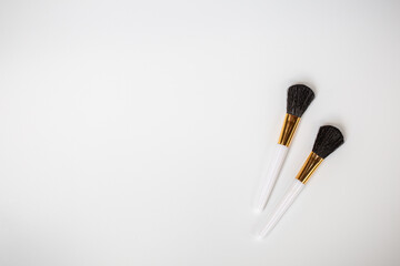 Wall Mural - Make up brushes with powder on white background