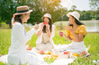 © torwaiphoto - Group of asian picnic friends in the morning,They are eating fruit.