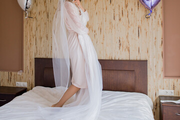 Poster - bride in peignoir holding a wedding dress