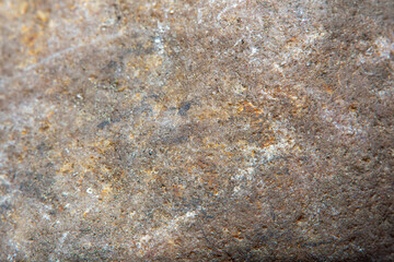 Wall Mural - Macro shooting of smooth stone surface with blurred background. Background with fine cobblestone texture.