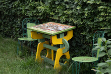 One Wood Vintage Table With Mosaic And 2 Beautiful Chairs In The Garden Of Memorial House Of George Toparceanu
