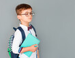 © Яна Солодкая - Childhood, education and people concept - happy smiling student boy with notebook over grey background