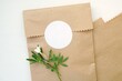Round blank sticker mockup, circle tag mock up on kraft paper gift bag, adhesive thank you card, round product label, pink flowers.