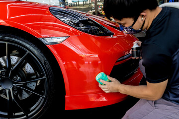 Wall Mural - Car service worker applying nano coating on a car detail