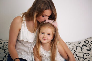 Wall Mural - Mother and daughter enjoying on the bed, happy smiling