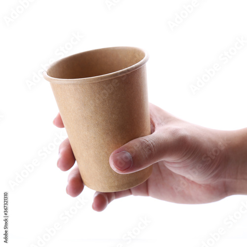 Download Hand Holding Craft Paper Cup Mockup Isolated Front View Empty Cardboard Container Mock Up For Drink Clear Disposable Coffee Mug Template Eco Kraft Paper Single Use For Picnic Studio Photography Stock Photo