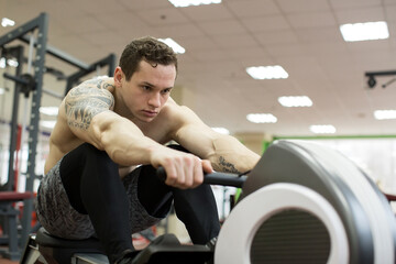 Man running rowing exercise in the gym