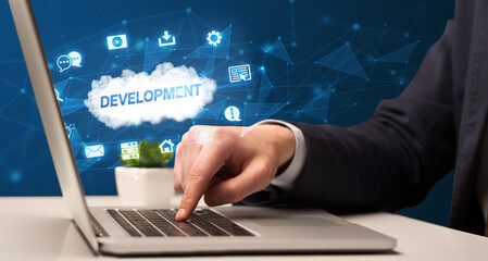 businessman working on laptop with development inscription, modern technology concept