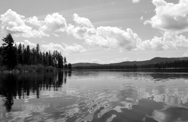 Wall Mural - Black & white ocean and lake scenes with dynamic active cloudy skies and water reflections