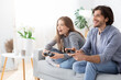 © Prostock-studio - Excited man and woman playing video games at home