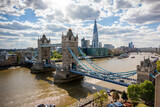 Fototapeta Londyn - Beautiful view to the Tower Bridge and modern skyline of London along the Thames river on a sunny day, United Kingdom