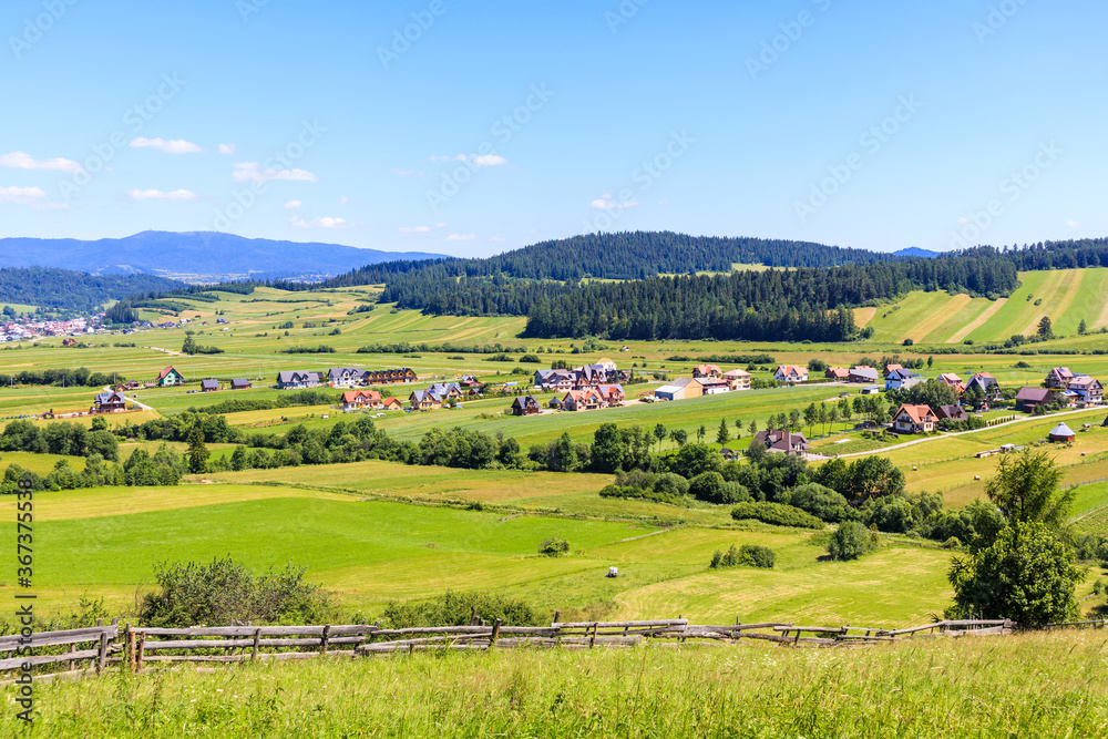 Stanin Green farming fields and view of Kacwin village in Tatra Mountains on ...