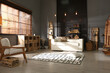 © New Africa - Shelving unit with stacked firewood and comfortable sofa in stylish room interior