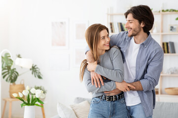 Wall Mural - Loving couple embracing at home, spending time together