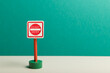 Child's wooden toy 'Do Not Enter' road sign with a teal background  