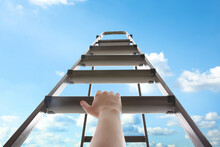 Woman Climbing Up Stepladder Against Blue Sky With Clouds, Closeup