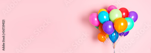 Cuadros en Lienzo Bunch of bright balloons on pink background, space for text