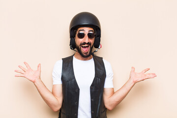 Wall Mural - young cool bearded man with a helmet surprised expression. motor