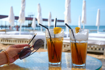 Cocktails on the beach. Bright cold drinks on the beach in summer. Summer vacation and travel concept.