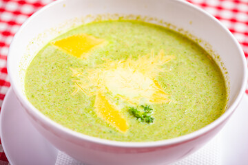 Wall Mural - Broccoli cream soup with cheese in white bowl. Close up