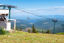 Empty Ski Lift Chairs On The Hillside Of The Mt Spokane State Park Ski Resort During Summer In Spokane, Washington, With Newman Lake In View