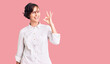 © Krakenimages.com - Beautiful young woman with short hair wearing elegant white shirt smiling positive doing ok sign with hand and fingers. successful expression.