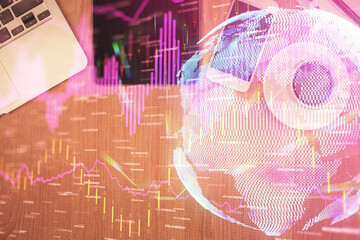 Double exposure of financial chart hologram over desktop with phone. Top view. Mobile trade platform concept.