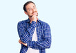 © Krakenimages.com - Young handsome caucasian man wearing casual clothes looking confident at the camera with smile with crossed arms and hand raised on chin. thinking positive.