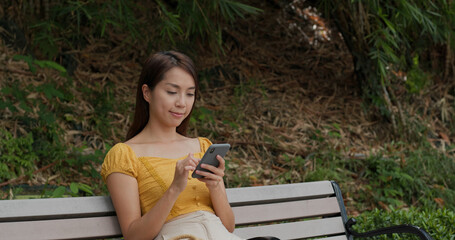 Canvas Print - Woman use of mobile phone in city park