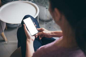 cell phone mockup image blank white screen.woman hand holding texting using mobile on desk at coffee shop.background empty space for advertise.work people contact marketing business,technology