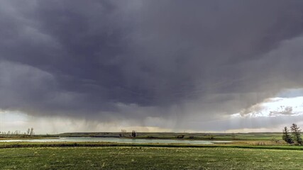 Wall Mural - Rainstorm time lapse over grassy field