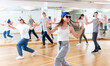 © JackF - Positive teenage girls and boys training hip hop in dance studio, dance classes for teens