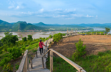 Tourist women walking on the bridge on the hill.