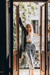© Tasha Sinchuk - Stylish fashionable blonde woman with smoky eye makeup, in jeans, white T-shirt and black leather jacket on the balcony in the doorway.Spring autumn fashion concept.Soft selective focus.