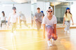 © JackF - Group of teenagers in casual clothes training hip-hop in class, learning modern dance movements