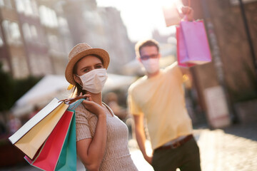 Sticker - A picture of couple with shopping bags and protective masks