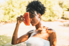 Attractive African Descent Woman With A Slice Of Watermelon In The Countryside. Healthy Lifestyle Concept