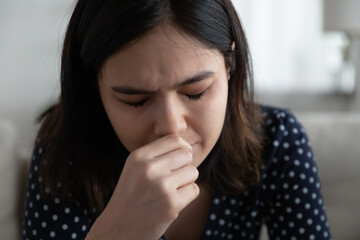 Close up of unhappy young Vietnamese woman cry suffer from mental psychological problems at home, upset millennial Asian girl feel lonely distressed, mourn or yearn, struggle with miscarriage problem