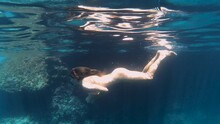 Woman Swimming Naked In Mediterranean Sea Under The Water