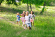 © master1305 - Kids, children running on meadow in summer's sunlight. Look happy, cheerful with sincere bright emotions. Cute caucasian boys and girls. Concept of childhood, happiness, movement, family and summer.